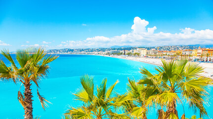 Nice city coastline with turquoise blue water, Cote D'Azure, French Riviera. Focus on the palms.