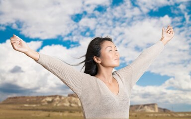 A cheerful young woman enjoying fresh air