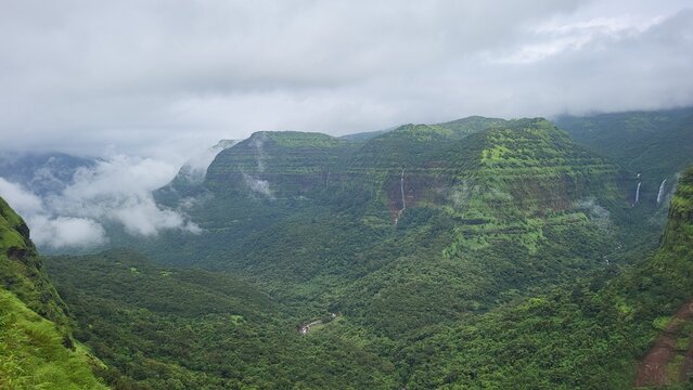 Panoramic landscape of the western ghats of India with clouds and multiple waterfalls, Varandha Ghat, Pune