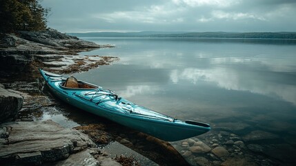 kayak. A kayak rests on the shoreline, reflecting calm blue waters in a serene natural setting. tourism brochures, itinerary planners, designed for travel destination branding.