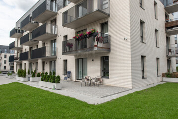 Modern Apartment Building with Balconies and Green Lawn
