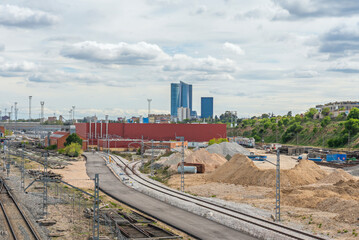 Fototapeta premium Section of commuter rail with rigid catenary electrification system in an urban tunnel, with safety lighting and maintenance crossings every 50 meters