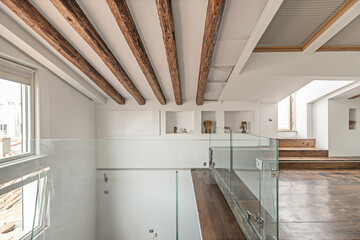 Spacious hallway with   connecting the two floors of the modern family home