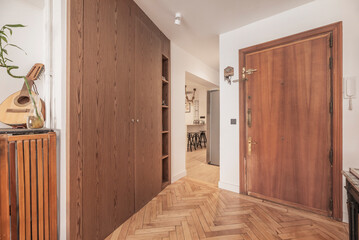 entryway with a marble main staircase, glass railing, and a skylight that floods the space with light