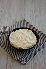 Organic White Mascarpone Cheese in a Bowl, side view.