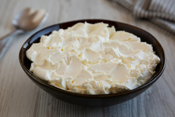 Organic White Mascarpone Cheese in a Bowl, side view.