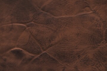 Rich, textured brown leather surface with natural wrinkles and folds, offering a warm, classic aesthetic for luxury designs.