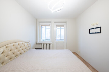 Fototapeta premium Modern Minimalist Bedroom With Large Bed and Bright Natural Lighting