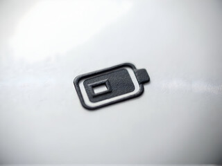 Fototapeta premium Low Battery Indicator Symbol Close Up on Surface