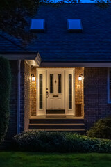 Entrance of luxury house with nice green Summer landscape at night in Vancouver, Canada, North America. August 2025