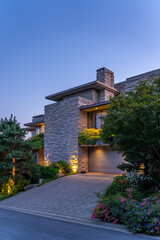 Entrance of luxury house with nice green Summer landscape at night in Vancouver, Canada, North America. August 2025
