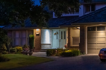 Entrance of luxury house with nice green Summer landscape at night in Vancouver, Canada, North America. August 2025