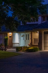 Entrance of luxury house with nice green Summer landscape at night in Vancouver, Canada, North America. August 2025