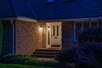 Entrance of luxury house with nice green Summer landscape at night in Vancouver, Canada, North America. August 2025