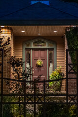 Entrance of luxury house with nice green Summer landscape at night in Vancouver, Canada, North America. August 2025