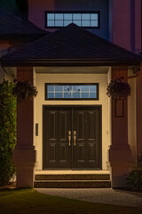 Entrance of luxury house with nice green Summer landscape at night in Vancouver, Canada, North America. August 2025