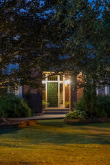 Entrance of luxury house with nice green Summer landscape at night in Vancouver, Canada, North America. August 2025
