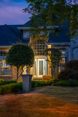Entrance of luxury house with nice green Summer landscape at night in Vancouver, Canada, North America. August 2025