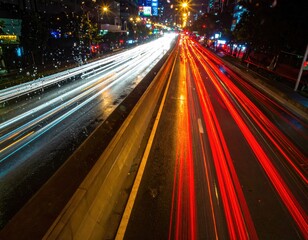 Obraz premium City Lights Stream: Captivating long exposure shot of a bustling cityscape at night, showcasing the vibrant trails of vehicle headlights and taillights.