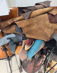 Leather scraps gathered in a workshop in the afternoon light