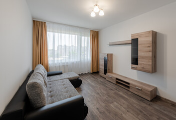 Living room with sofa and cupboards. White Walls.