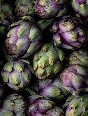 Obraz premium Fresh artichokes closeup. Macro flat lay of green and purple Italian artichokes with layered textured leaves.