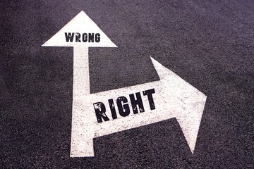 wrong and right concept. words written on a sign on the asphalt. arrows pointing in different directions
