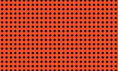 A repeating pattern of black starburst shapes on an orange background creating a dense texture