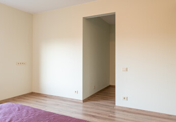 Minimalist Bedroom Interior with Wooden Bed and Purple Bedding