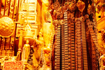 Gold jewelry with the golden reflect light background. Gold is safe assets during war and economic crisis.  Financial concepts.