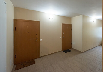 Modern Apartment Hallway with Closed Doors and Illuminated Wall Lights