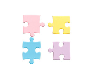 Fototapeta premium Four pastel-colored puzzle pieces arranged in a square