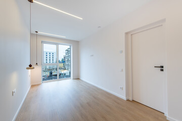 Modern Empty Room with Wooden Floor and Large Window Overseeing Construction