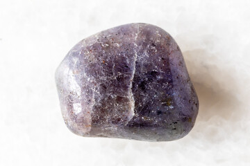 sample of tumbled cordierite mineral on white