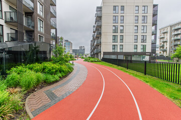 Modern Residential Apartment Complex with Jogging Path and Green Outdoor Area
