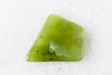 polished light green nephrite rock on white