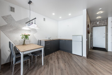 Modern Minimalist Home Dining Area with Wood Flooring and Stylish Kitchen