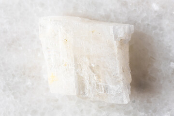 sample of raw colorless calcite mineral on white