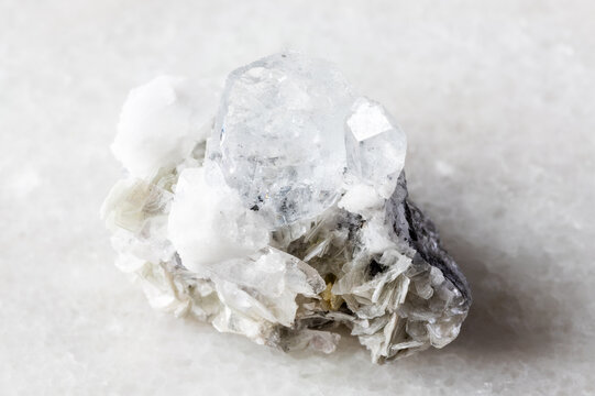 goshenite with mica and feldspar mineral on white