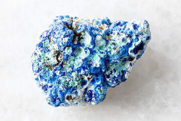 raw azurite and gibbsite mineral on white marble