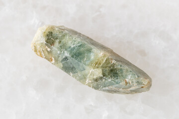 rough green sapphire corundum crystal on white