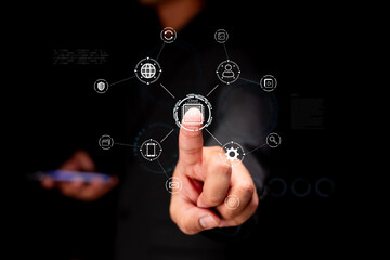 A person interacts with digital icons using a touchscreen interface, symbolizing technology and connectivity in a modern environment.