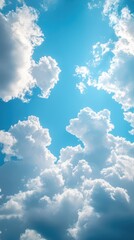 Bright blue sky with fluffy white clouds during a sunny day in the afternoon