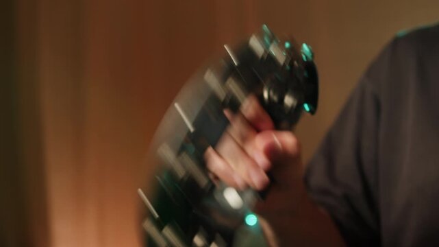 Musical instrument, tambourine Percussion, man playing in studio, sound and creativity. Plastic tambourine in a mans hand.