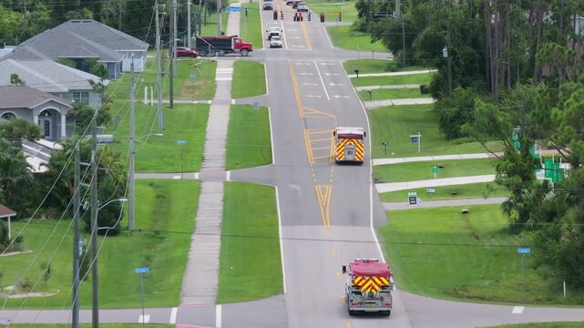 Drone view of fire truck responding to emergency on Florida roadway, showing emergency lighting and service insignia.