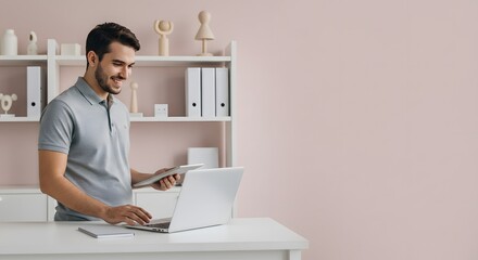 Smiling Man Working Efficiently in His Modern Home Office with Laptop and Tablet