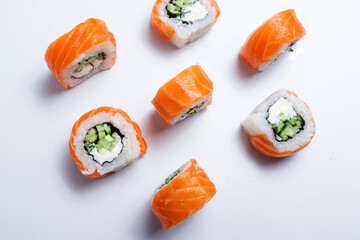 Elegant sushi rolls with salmon, avocado, and cream cheese, served with wasabi and ginger