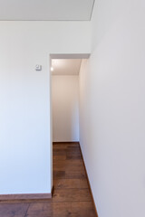 Empty Minimalist Room with Wooden Floors and White Walls