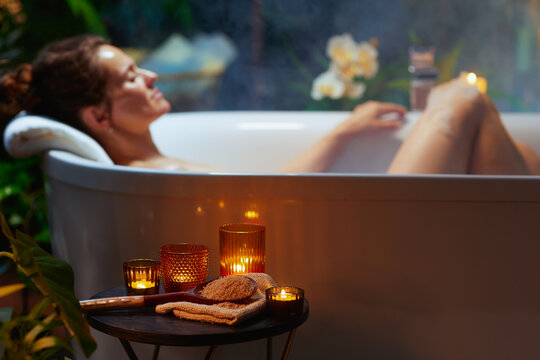 Woman Relaxing in Candlelit Bathtub - Powered by Adobe