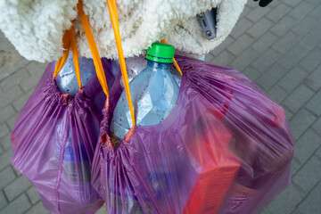 Plastic bottles collected for recycling. Plastic bottles in a bag emphasizing responsible consumption and ecological initiatives. Water bottles ready for deposit in an automatic recycling machine.